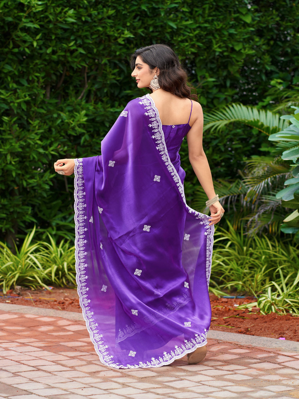 Golden Radiance: Highlighting the glowing tone of the beige shimmer chiffon saree.
