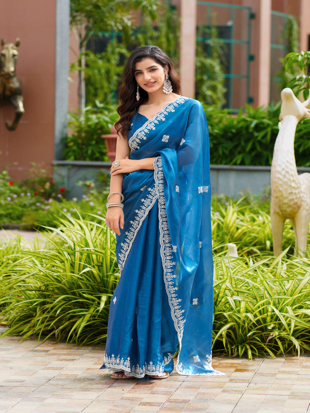 Golden Radiance: Highlighting the glowing tone of the beige shimmer chiffon saree.