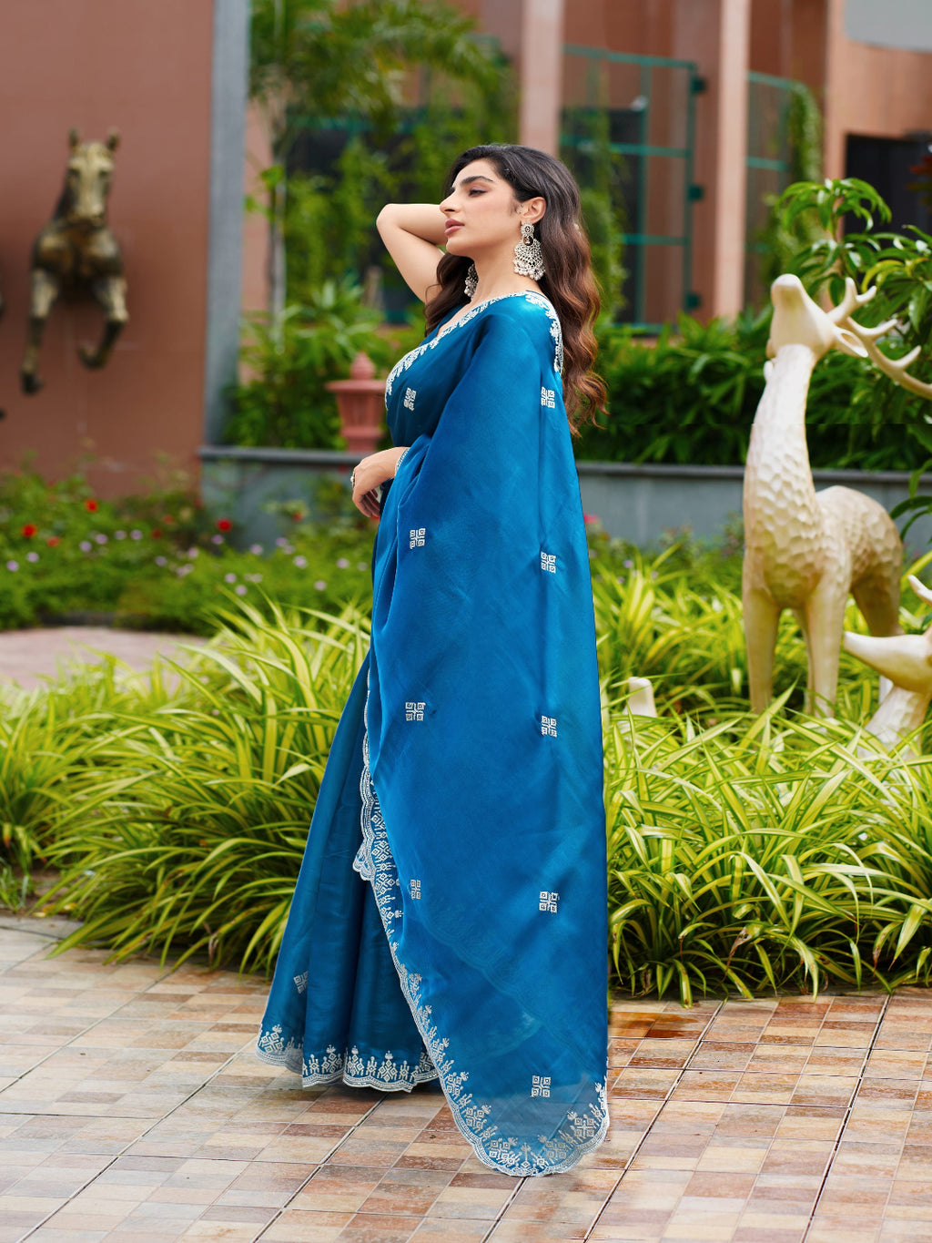 Golden Radiance: Highlighting the glowing tone of the beige shimmer chiffon saree.