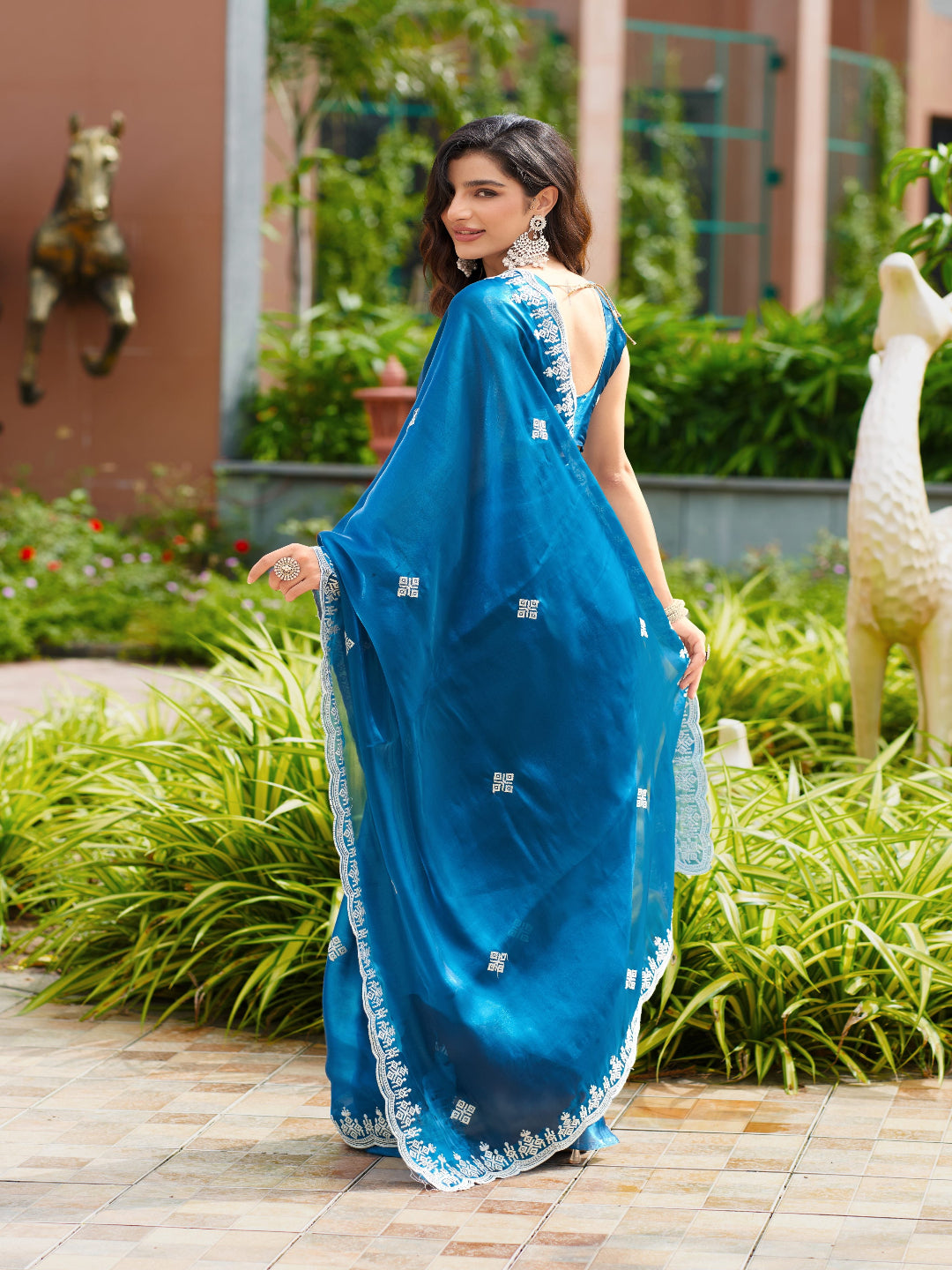 Golden Radiance: Highlighting the glowing tone of the beige shimmer chiffon saree.