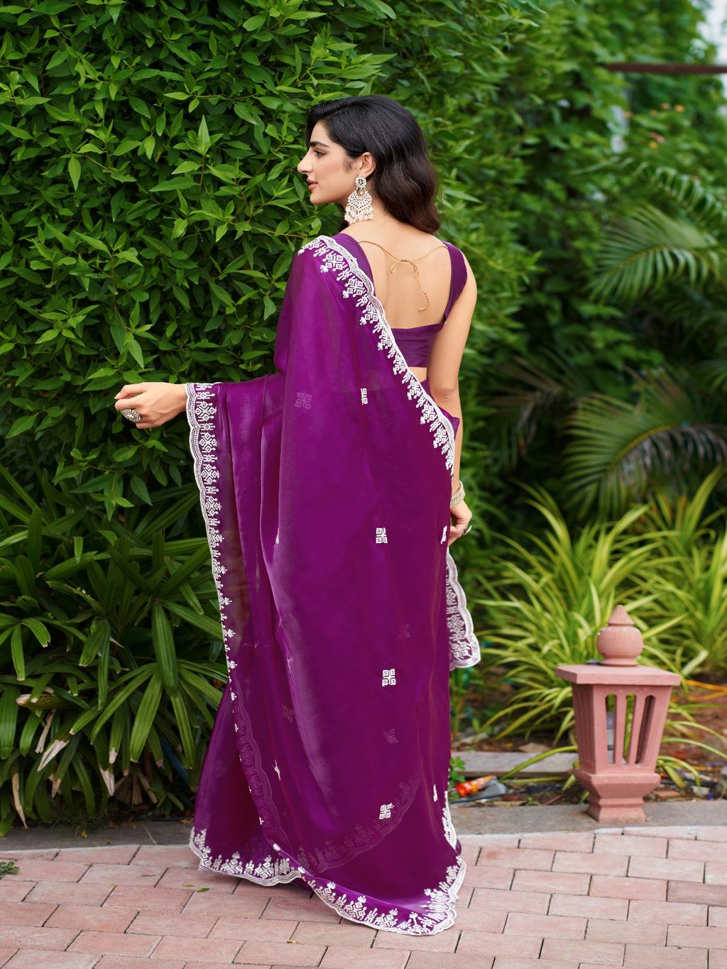Golden Radiance: Highlighting the glowing tone of the beige shimmer chiffon saree.