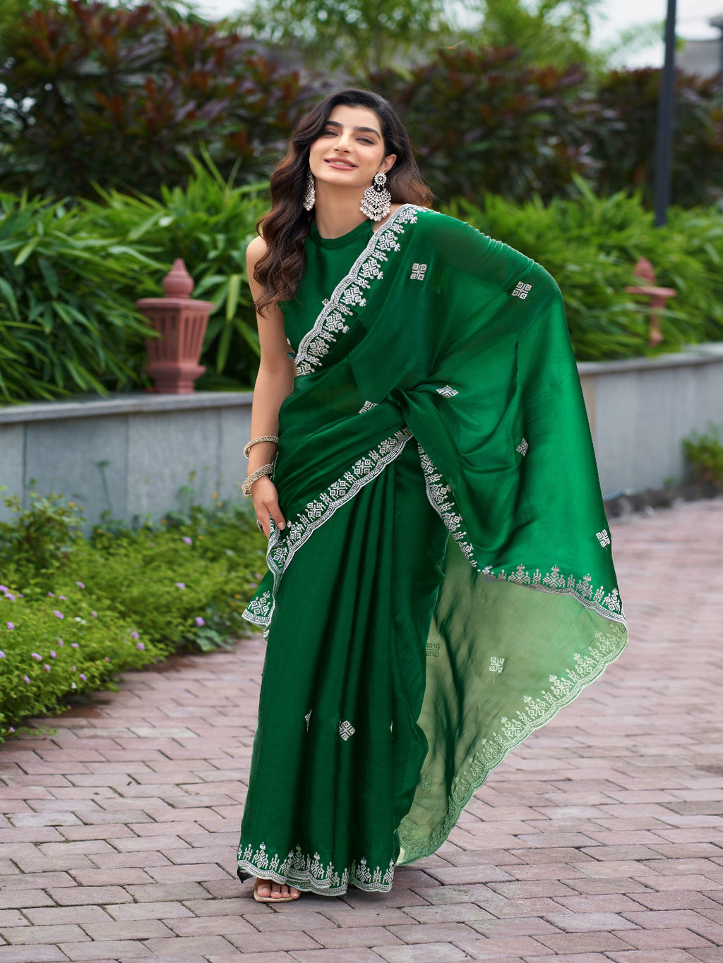 Golden Radiance: Highlighting the glowing tone of the beige shimmer chiffon saree.