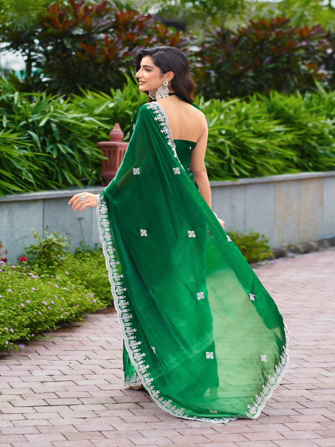 Golden Radiance: Highlighting the glowing tone of the beige shimmer chiffon saree.