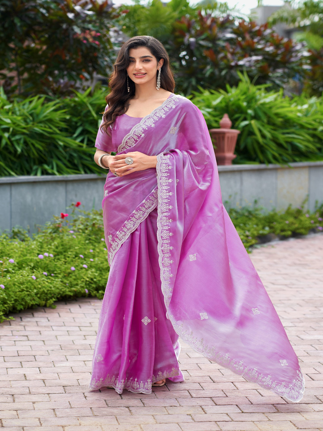 Golden Radiance: Highlighting the glowing tone of the beige shimmer chiffon saree.