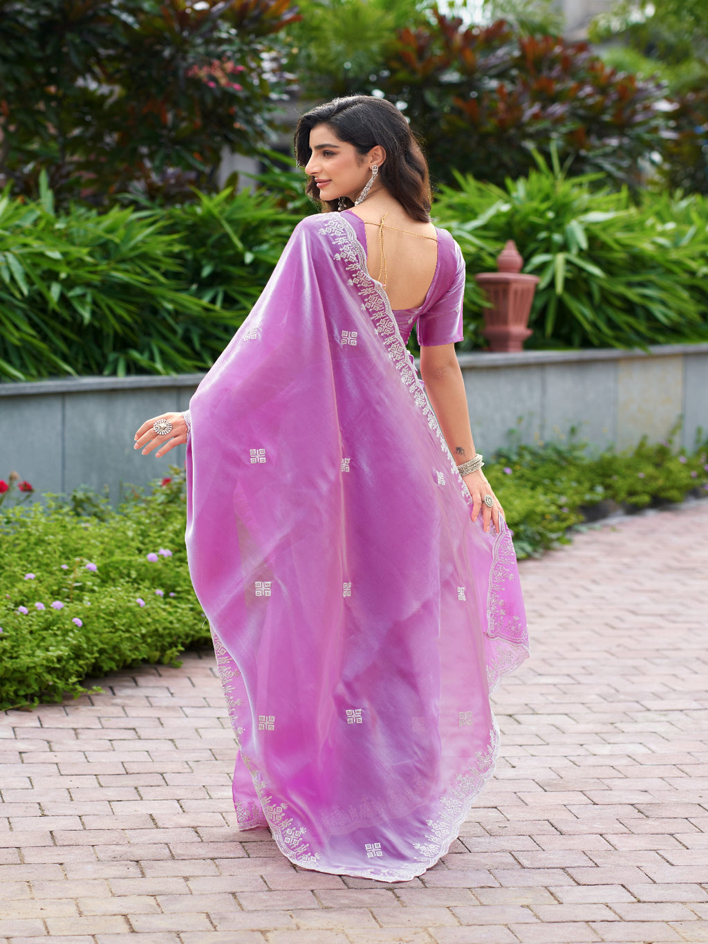 Golden Radiance: Highlighting the glowing tone of the beige shimmer chiffon saree.
