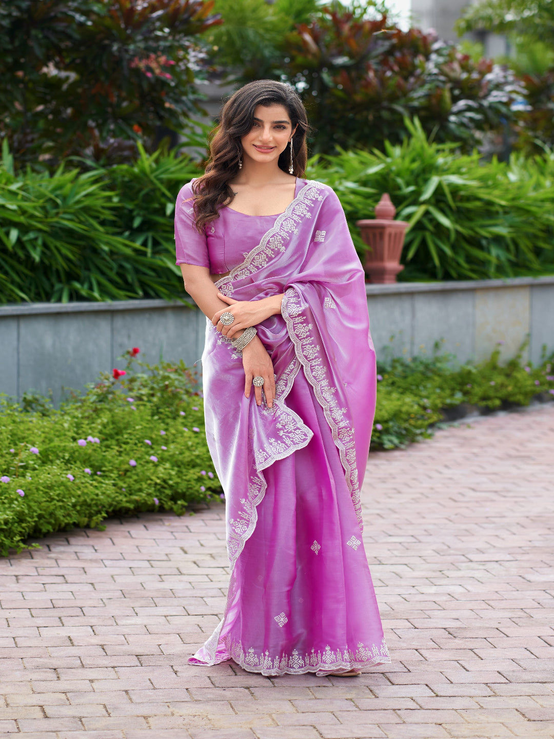 Golden Radiance: Highlighting the glowing tone of the beige shimmer chiffon saree.