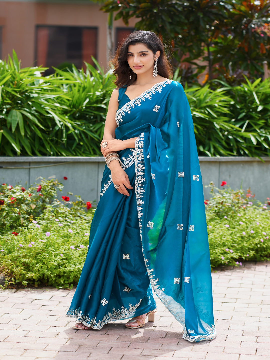 Golden Radiance: Highlighting the glowing tone of the beige shimmer chiffon saree.
