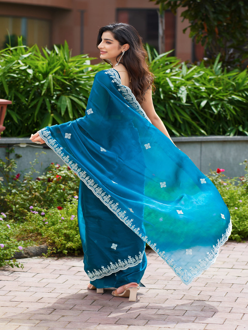 Golden Radiance: Highlighting the glowing tone of the beige shimmer chiffon saree.