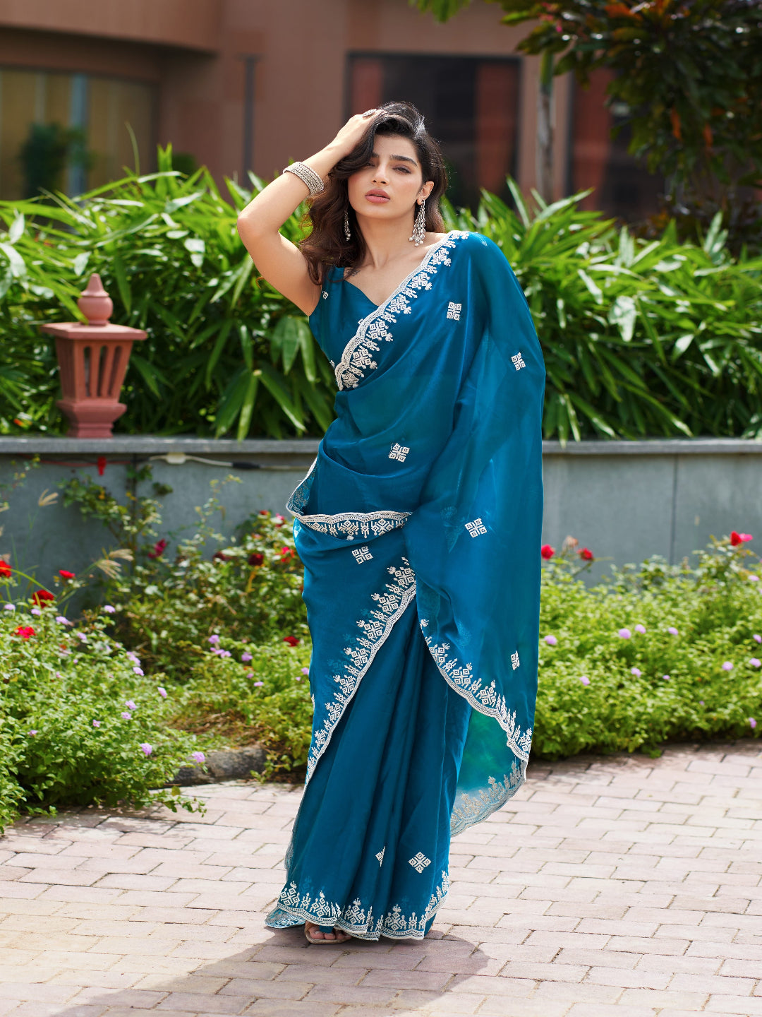 Golden Radiance: Highlighting the glowing tone of the beige shimmer chiffon saree.