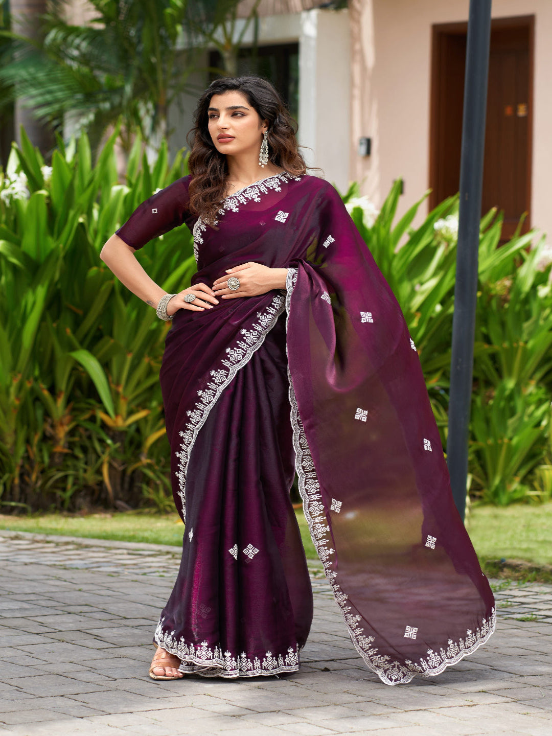 Golden Radiance: Highlighting the glowing tone of the beige shimmer chiffon saree.