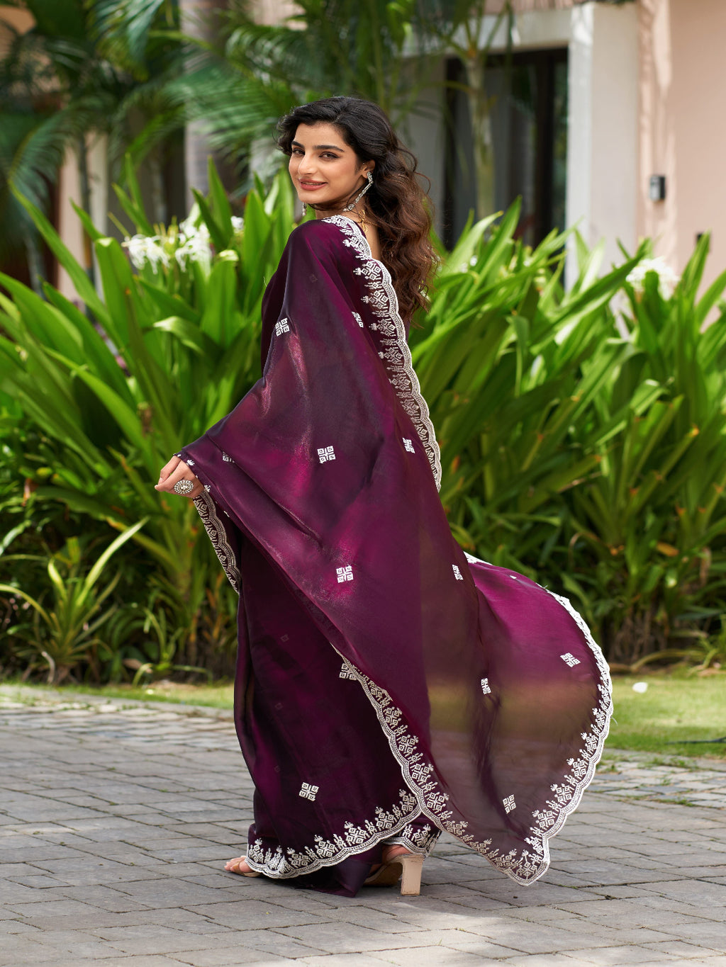 Golden Radiance: Highlighting the glowing tone of the beige shimmer chiffon saree.