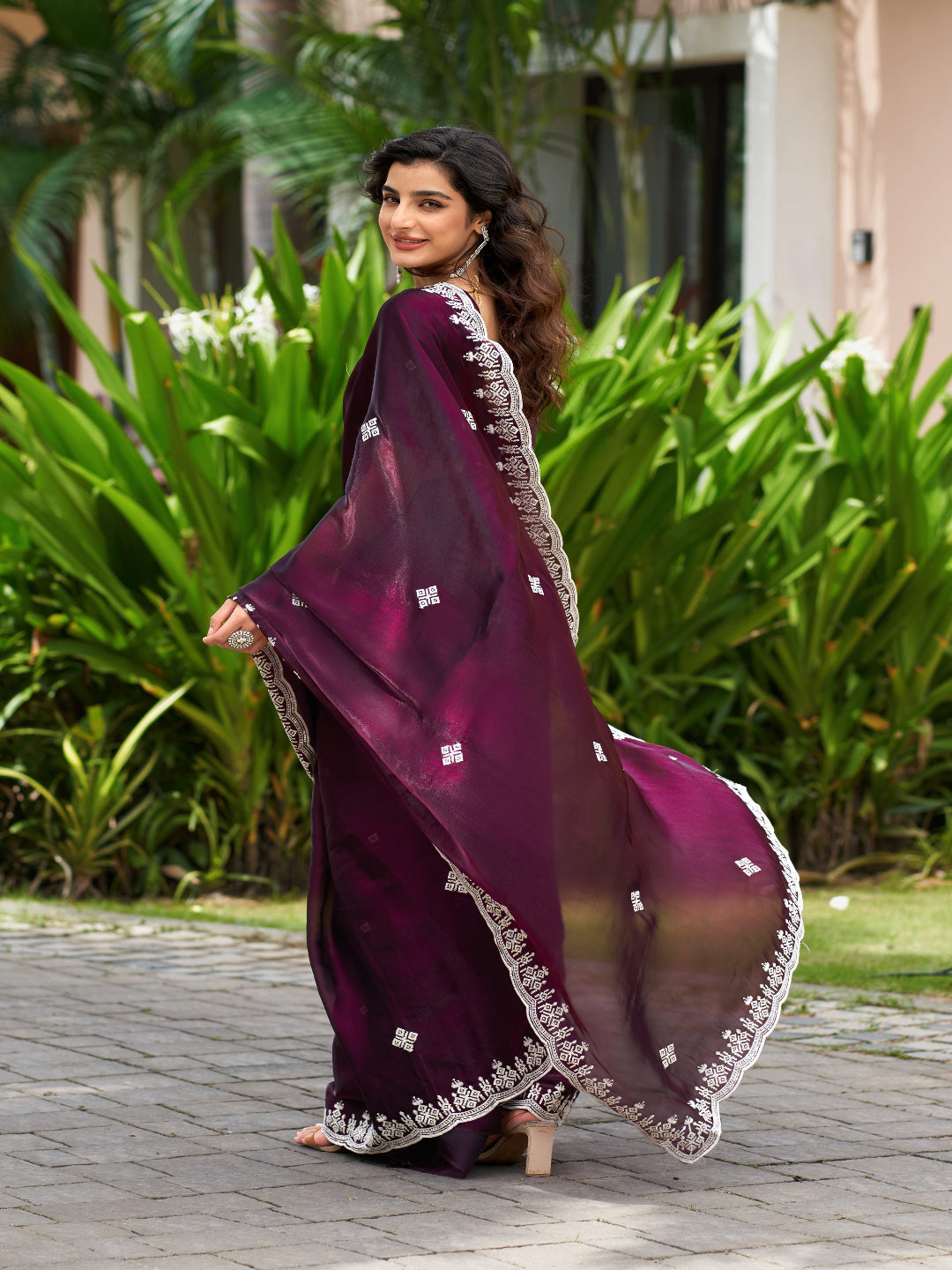 Golden Radiance: Highlighting the glowing tone of the beige shimmer chiffon saree.