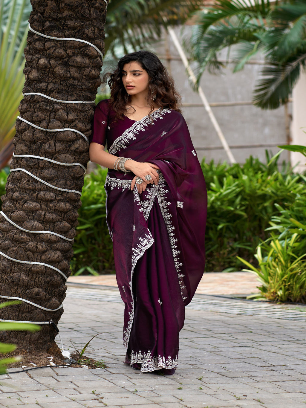 Golden Radiance: Highlighting the glowing tone of the beige shimmer chiffon saree.