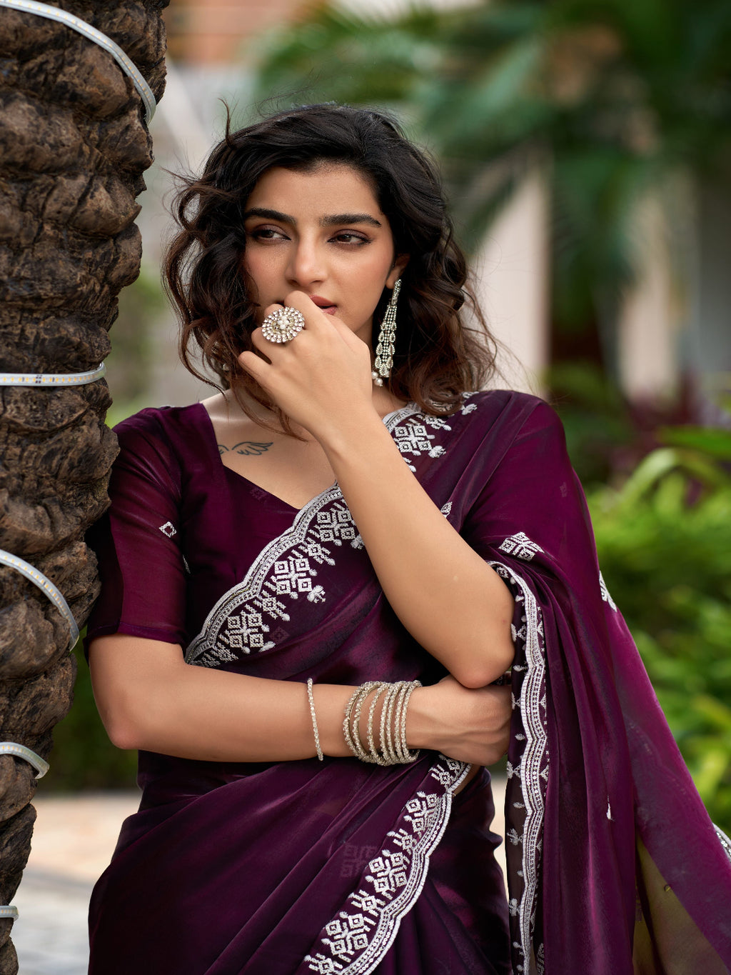 Golden Radiance: Highlighting the glowing tone of the beige shimmer chiffon saree.