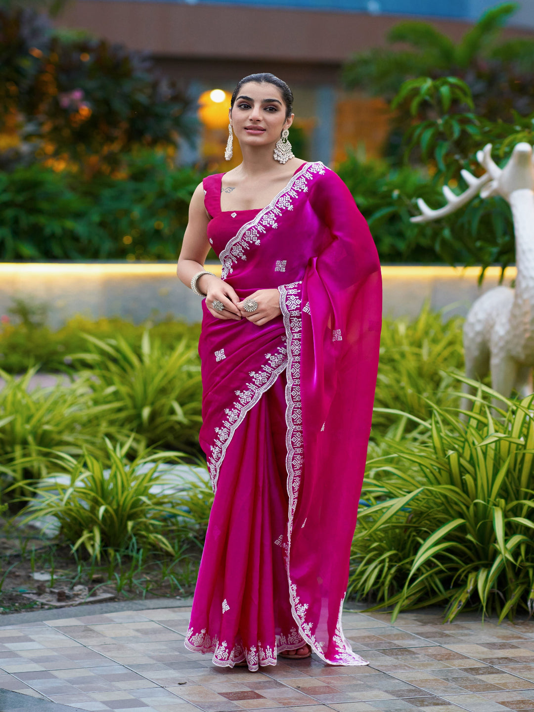 Golden Radiance: Highlighting the glowing tone of the beige shimmer chiffon saree.