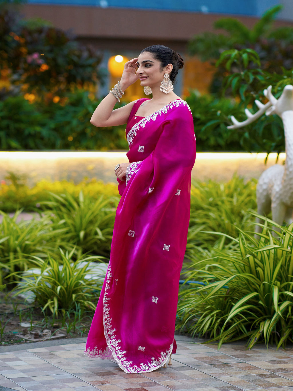 Golden Radiance: Highlighting the glowing tone of the beige shimmer chiffon saree.