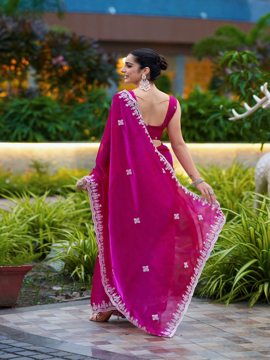 Golden Radiance: Highlighting the glowing tone of the beige shimmer chiffon saree.