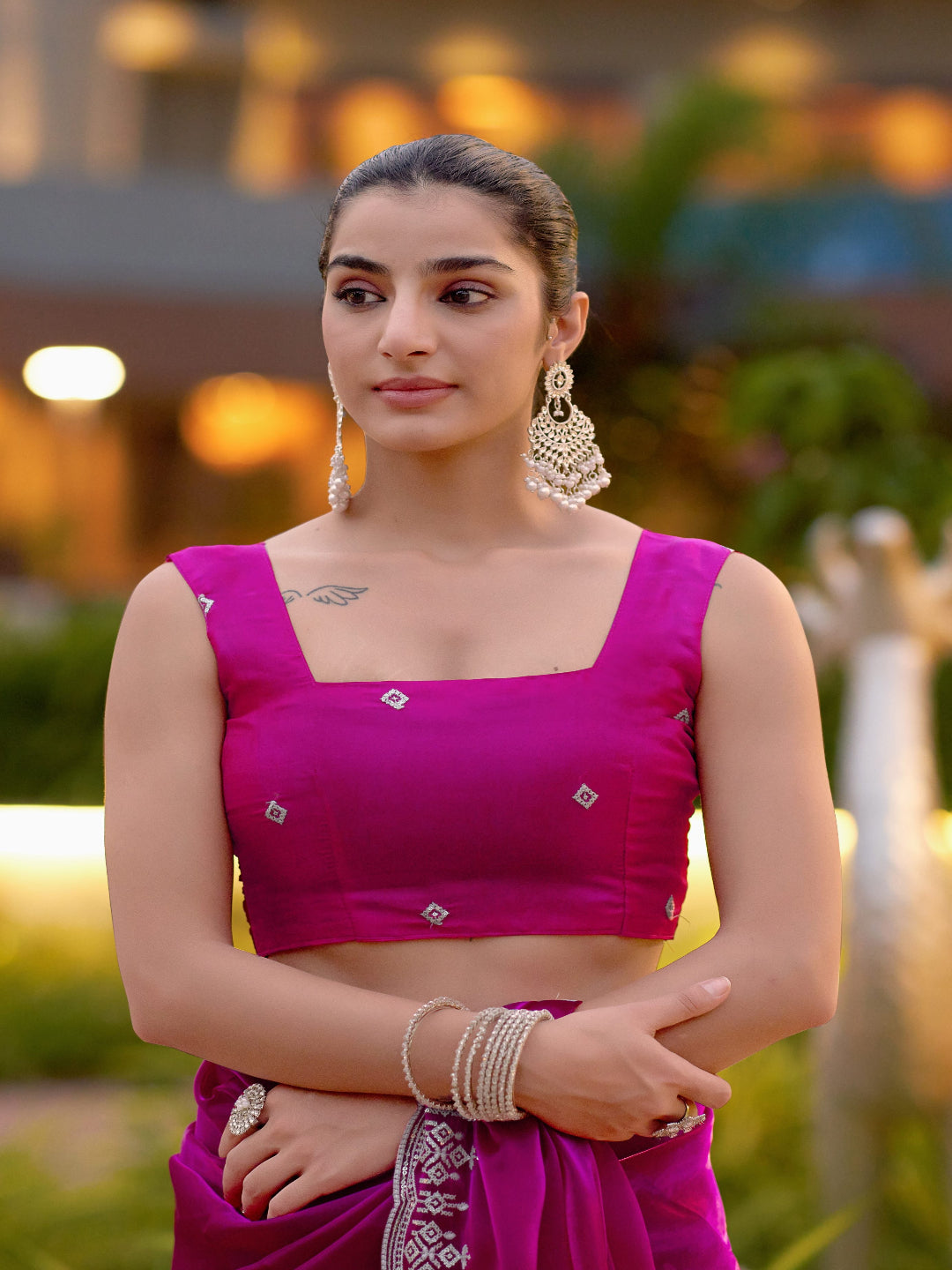 Golden Radiance: Highlighting the glowing tone of the beige shimmer chiffon saree.