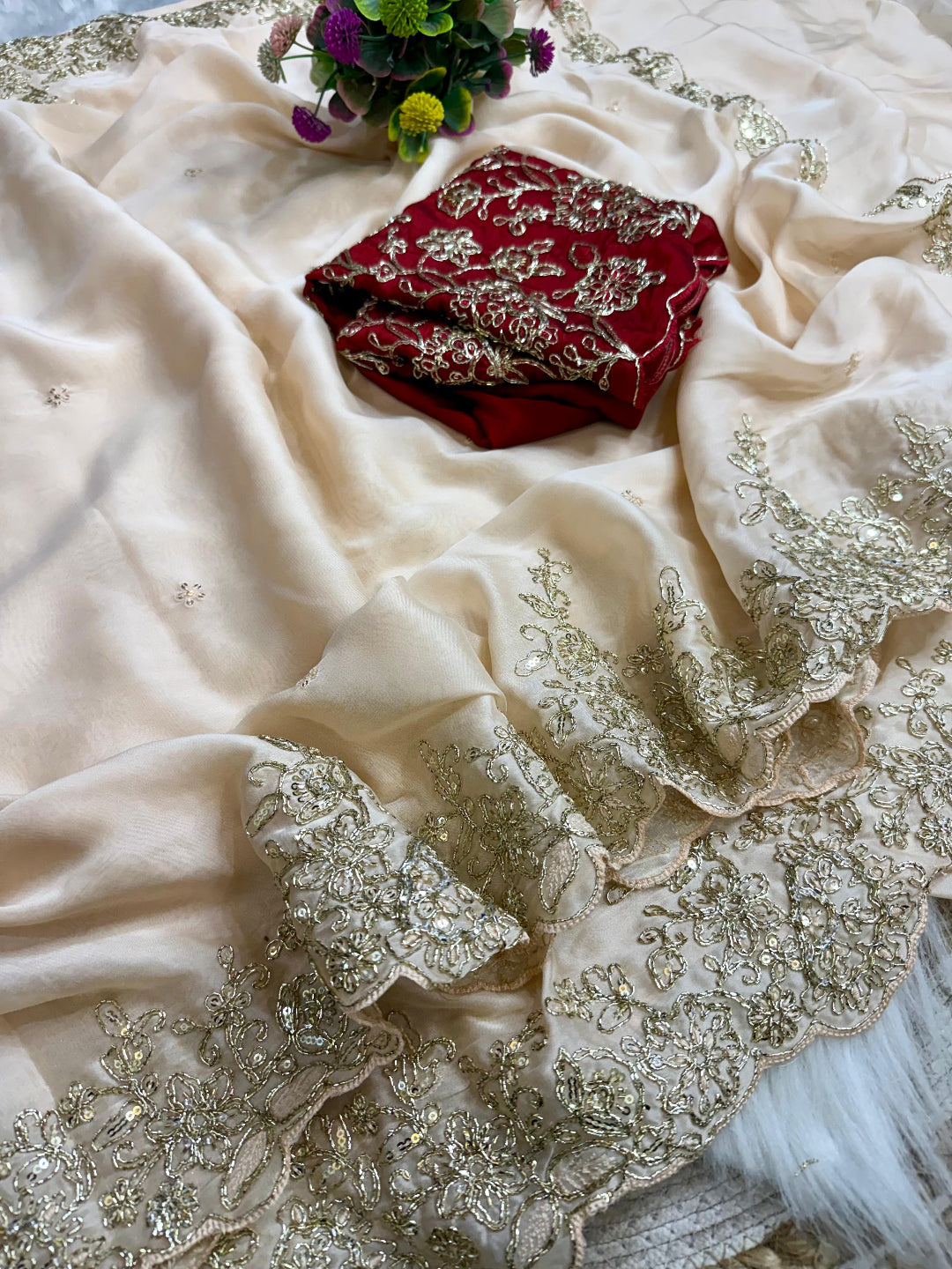 ivory saree crafted from silk with detailed gold Zardosi embroidery