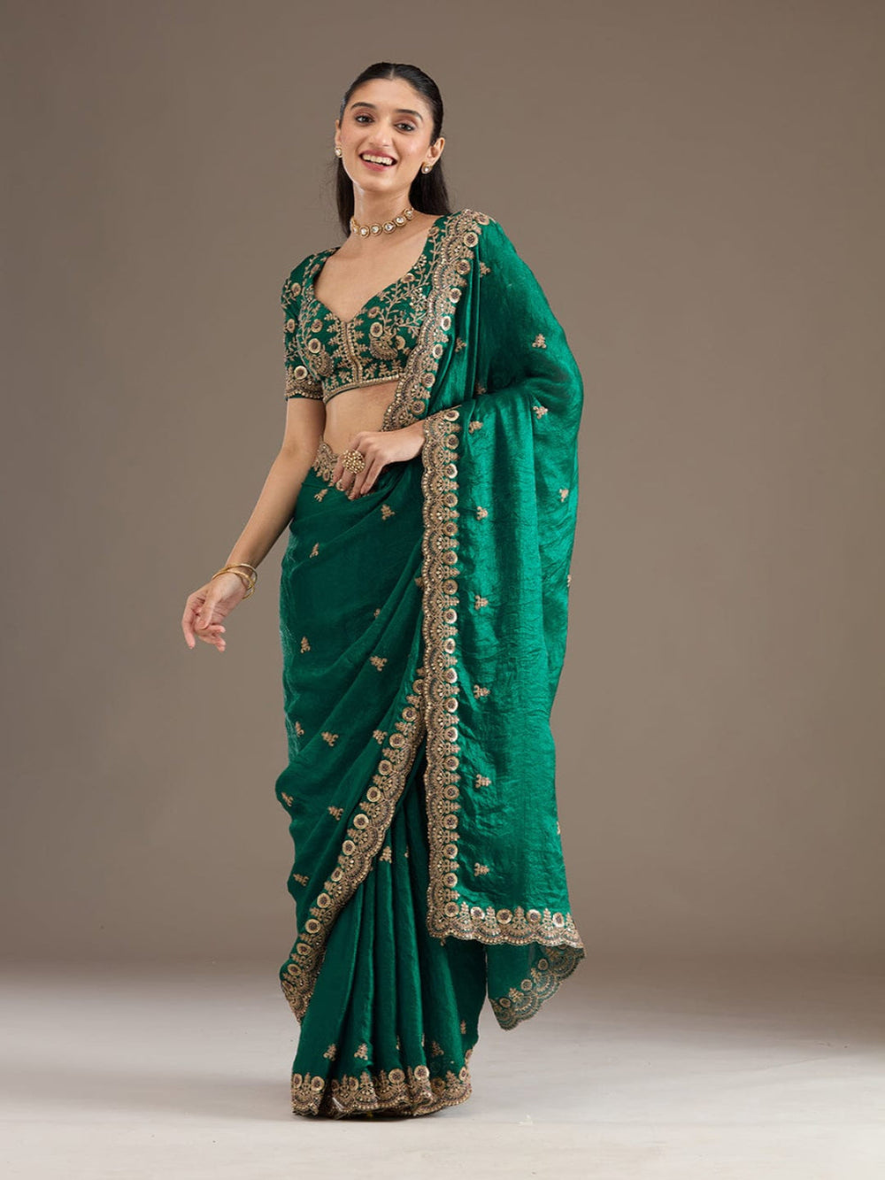 Elegant Emerald Green Embroidered Saree with Heavy Golden Designer Border – Wedding & Festive Wear